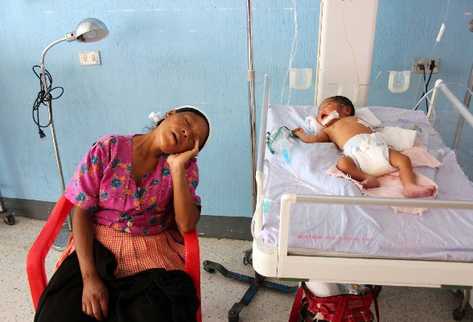 Una madre duerme junto a la cuna en la que su pequeño se recupera, en el Hospital Regional de Jalapa, donde se ha reportado un repunte de casos desnutrición.