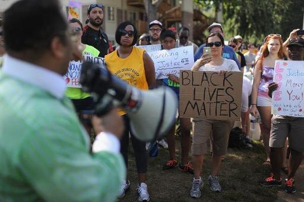Manifestantes marchan y exhiben carteles por la igualdad en Estados Unidos. (Foto Prensa Libre: AFP)