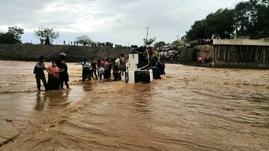 Curiosos rescatan a personas que viajaban en camión que cayó en el río Túnico, en Izabal. (Foto Prensa Libre: Eduardo Sam)