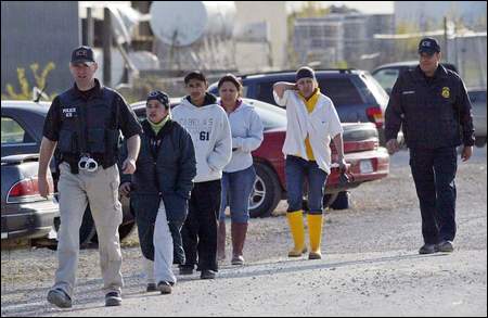 Agentes de Inmigración dirigen un grupo de migrantes luego de su captura en Iowa el 13 de mayo de 2008. (Foto: The Registrer)