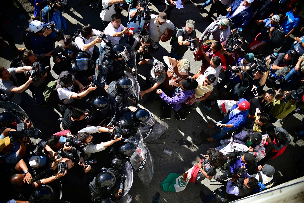 Vista aérea de los migrantes centroamericanos, principalmente de Honduras, detenidos por agentes de la policía federal cerca del puerto de entrada de El Chaparral. (Foto Prensa Libre: AFP)