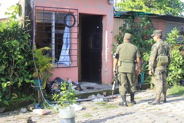Dos soldados permanecen frente a la casa donde fue el ataque. (Foto Prensa Libre: Enrique Paredes)