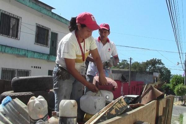 Personal de  la Cruz Roja recolecta plásticos para evitar criaderos de zancudos. (Foto Prensa Libre: Édgar Girón)