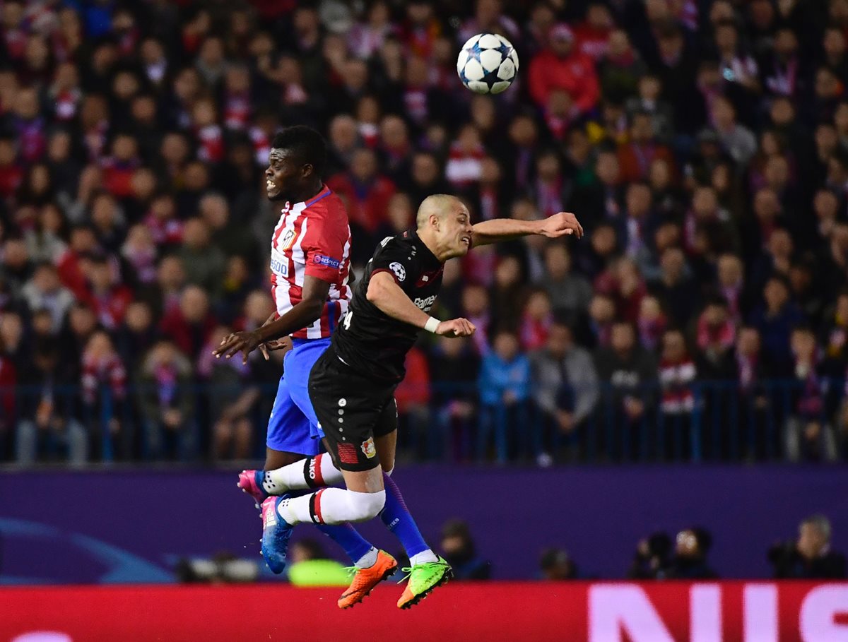 El delantero mexicano Javier Hernandez (d) disputa el esférico con Thomas Partey, del Atlético Madrid, en duelo disputado en el estadio Vicente Calderón (Foto Prensa Libre: AFP)