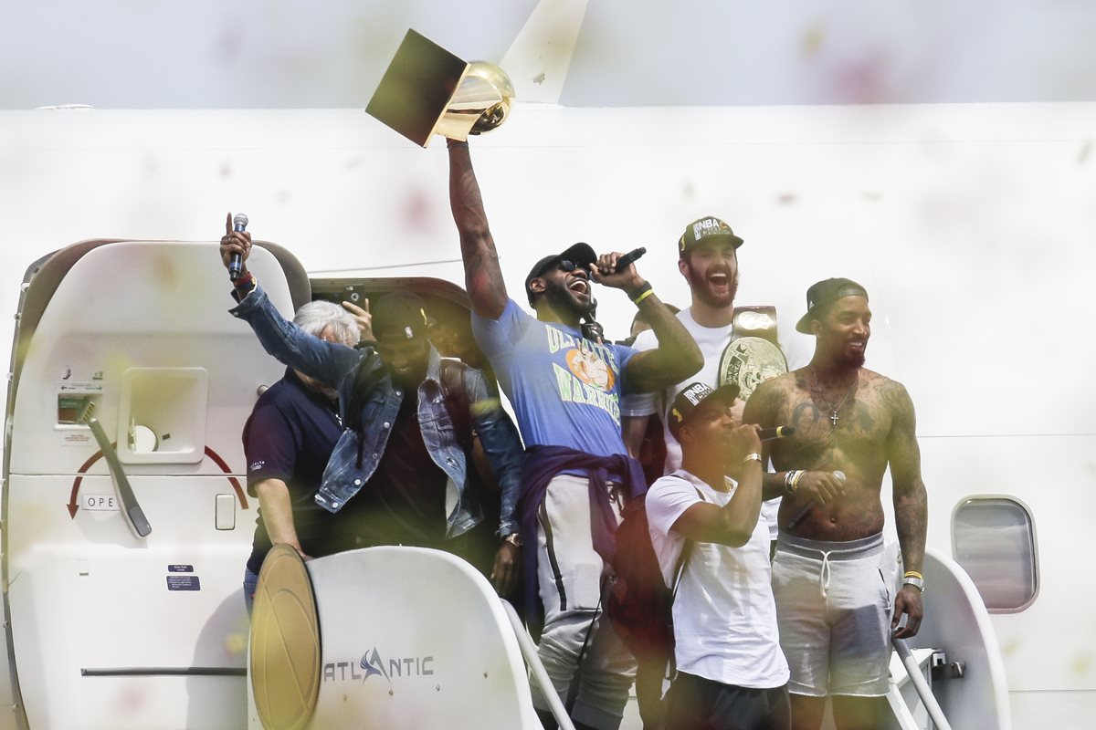 LeBron James desciende del avión con el trofeo de campeón, tras su arribo a Cleveland. (Foto Prensa Libre: AP).