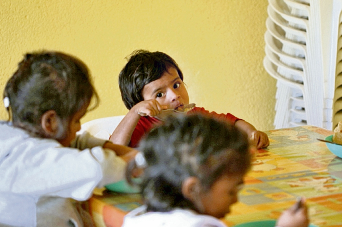 A los  niños de mayor edad  les explican sobre los nutrientes que tienen los alimentos que consumirán.