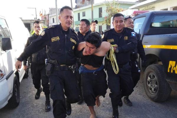 El supuesto atacante de la mujer y su hija en Villa Lobos, Villa Nueva es sometido por agentes de la PNC (Foto Prensa Libre: José M. Patzán)<br _mce_bogus="1"/>