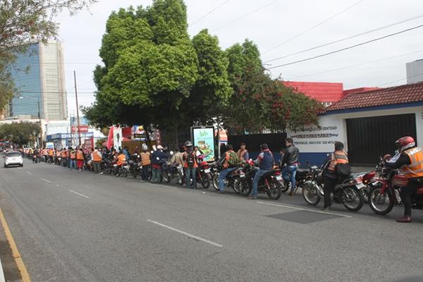 Cientos de motoristas hacen cola para recibir servicio de aceite gratuito en un taller de la zona 4. (Foto Prensa Libre: Leonel Sión)