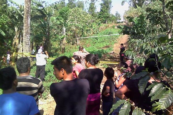Vecinos observan el lugar donde fueron hallados los cuerpos baleados de dos hombres en San Felipe, Retalhuleu. (Foto Prensa Libre: Jorge Tizol)