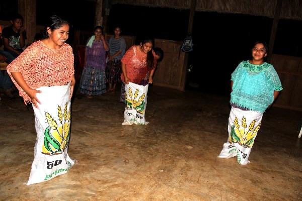 Señoritas participan en una competencia de  encostalados, durante uno de los talleres.