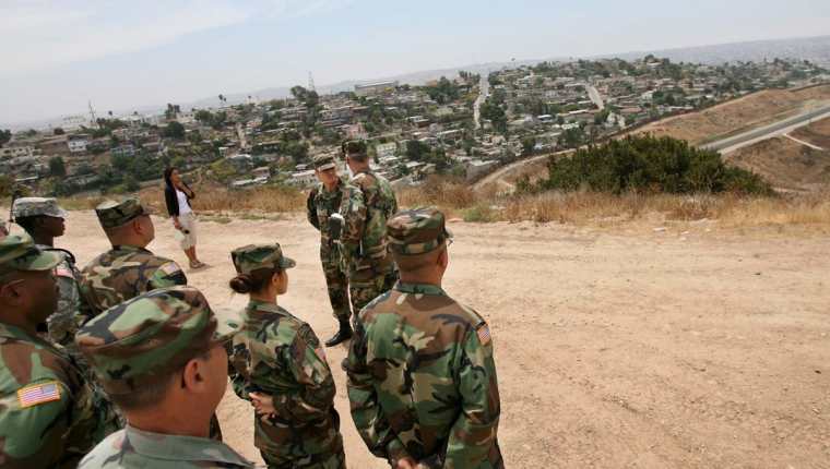 Efectivos de la Guardia Nacional observan hacia Tijuana en México, frontera con Estados Unidos cerca a Otay Mesa, California.(Foto Prensa LIbre:EFE).
