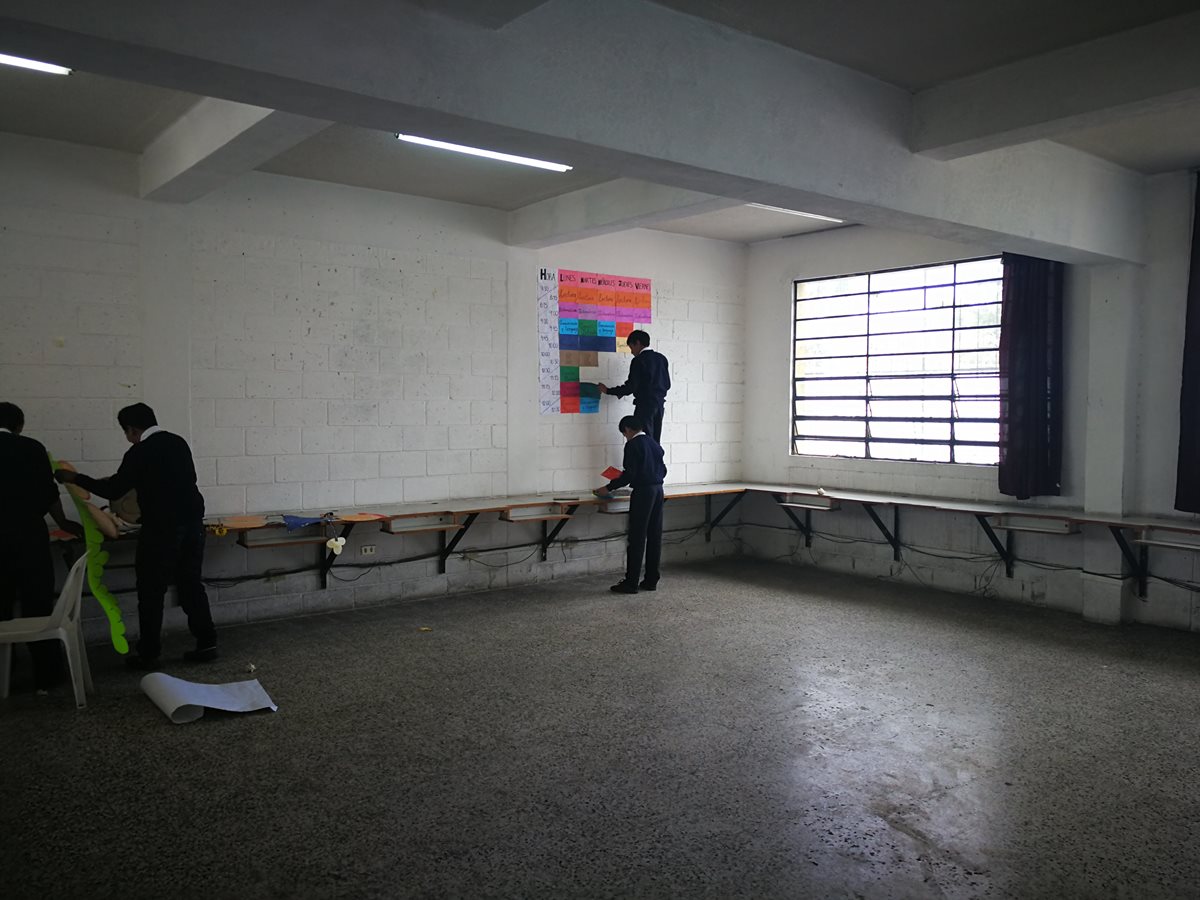 Después de sacar sus escritorios al patio los estudiantes retiran el material de clase.(Foto Prensa Libre: José Patzán)