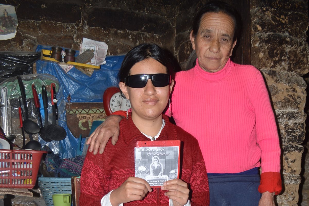 Elizabeth Rojas y su madre, Gladys Cifuentes, enseñan la portada de uno de sus discos grabados con música cristiana. (Foto Prensa Libre: Lucero Sapalú)