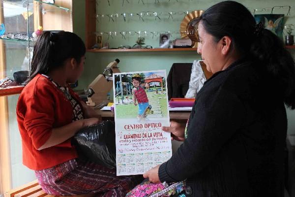 En Chimaltenango, una mujer recibe un calendario que le obsequió una óptica.
