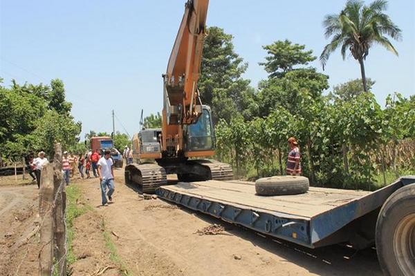 Una de las máquinas que era usada para construir bordas en el río Coyolate  es subida a una plataforma, en Nueva Concepción. (Foto Prensa Libre: Enrique Paredes)