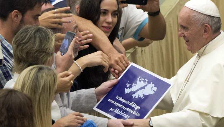 <em>Momento en el que el Papa sostiene brevemente el rótulo a favor del diálogo por las Malvinas.(Foto Prensa Libre: AP).</em>