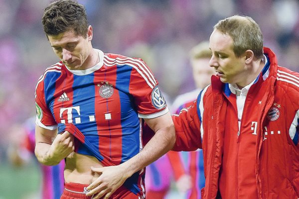 Robert Lewandowski abandonó la cancha junto al médico del club Volker Braun luego de chocar con el portero del Dortmund Mitchell Langerak. (Foto Prensa Libre: AFP).