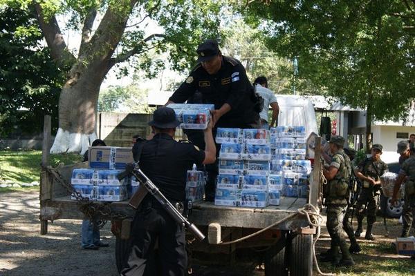 Policías cargan parte de licor decomisado durante los cateos efectuados en municipios de Quetzaltenango. (Foto Prensa Libre: Alexánder Coyoy)<br _mce_bogus="1"/>