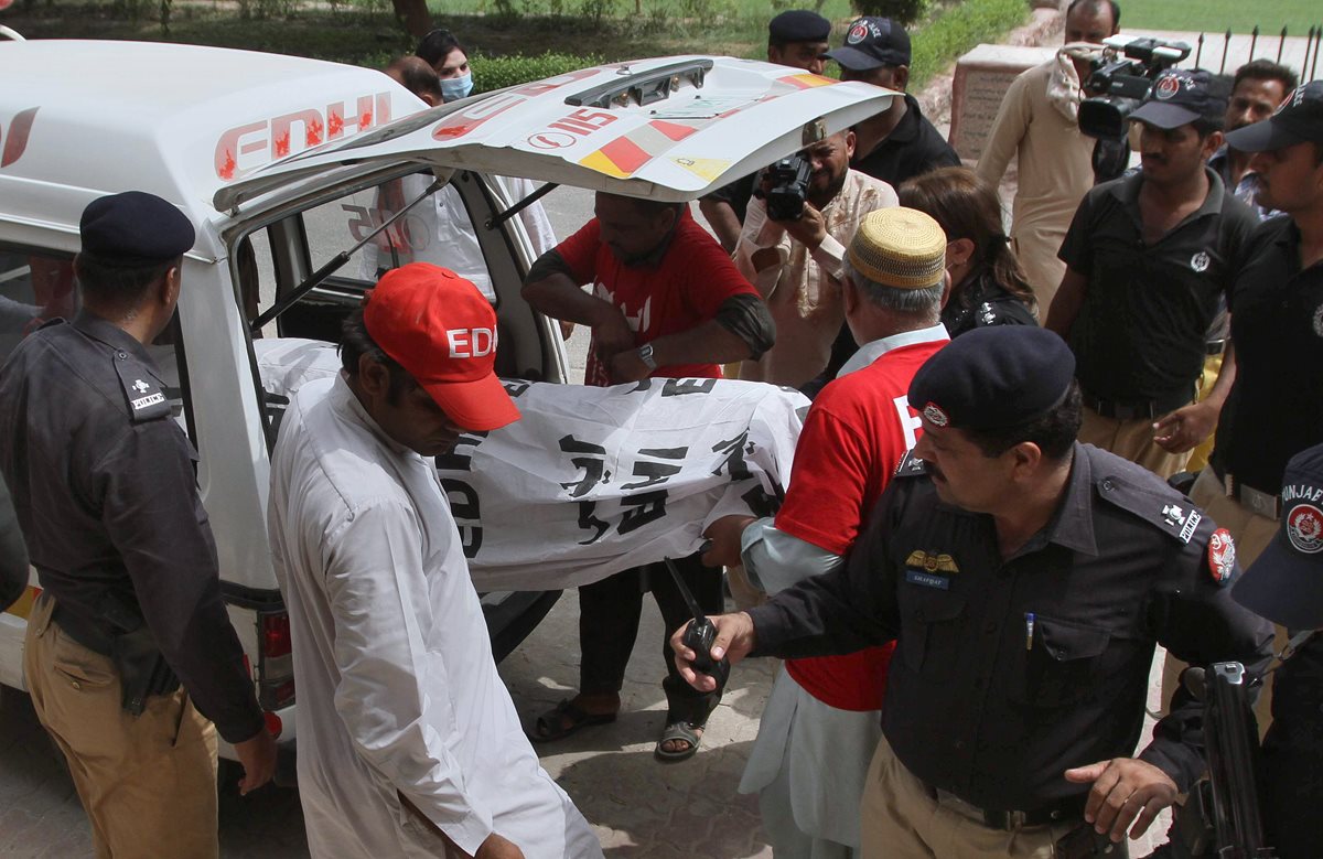 Oficiales paquistaníes resguardan la ambulancia donde trasladaron el cuerpo de la modelo Qandeel Baloch. (Foto Prensa Libre: AP).