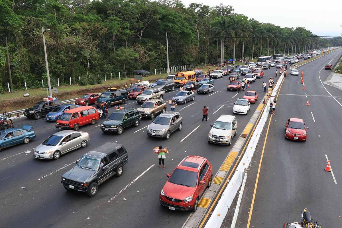 Automovilistas efectuaron hasta cuatro kilómetros de filas para pasar por el peaje de la autopista Palín-Escinta. (Foto Prensa Libre: Enrique Paredes)