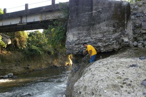vecino señala la base  del puente    que está  dañada  debido  a la  crecida   del río Siguacán, en la aldea Día de Reyes, Santa Bárbara, Suchitepéquez.