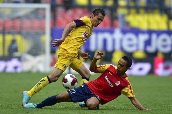 El jugador del América, Paulo Aguilar, intenta superar la marca de   Francisco Torres, del  Morelia. (Foto Prensa Libre: AFP)