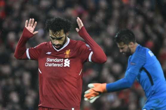 Liverpool's Egyptian midfielder Mohamed Salah celebrates after scoring their second goal during the UEFA Champions League first leg semi-final football match between Liverpool and Roma at Anfield stadium in Liverpool, north west England on April 24, 2018. / AFP PHOTO / Filippo MONTEFORTE