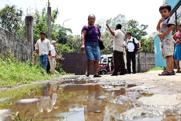 Vecinos caminan por sector donde corren aguas servidas de alcantarilla dañada.