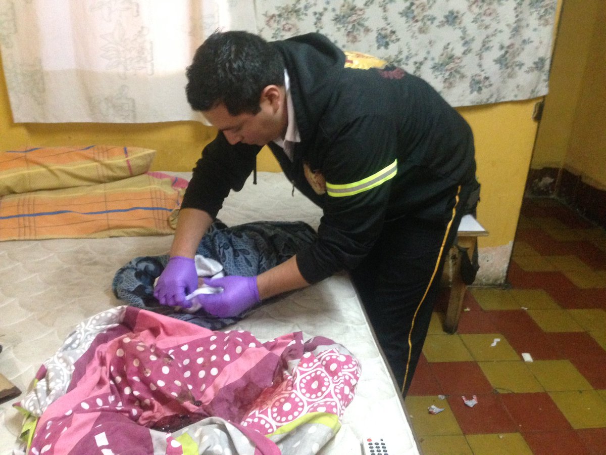 Un socorrista evalúa a una bebé que fue abandonada en un hotel de la zona 7 capitalina. (Foto Prensa Libre: Bomberos Voluntarios).