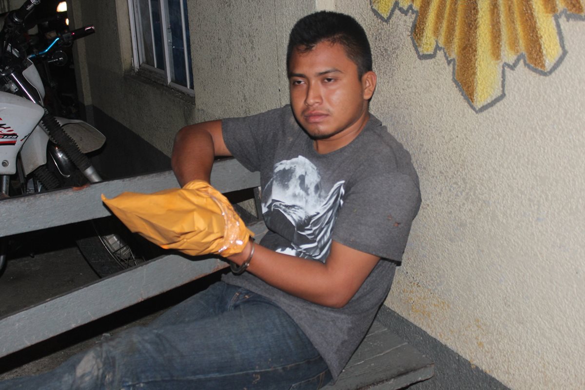 Uno de los presuntos secuestradores es trasladado hacia una subestación de la PNC en Lívingston. (Foto Prensa Libre: Edwin Perdomo)