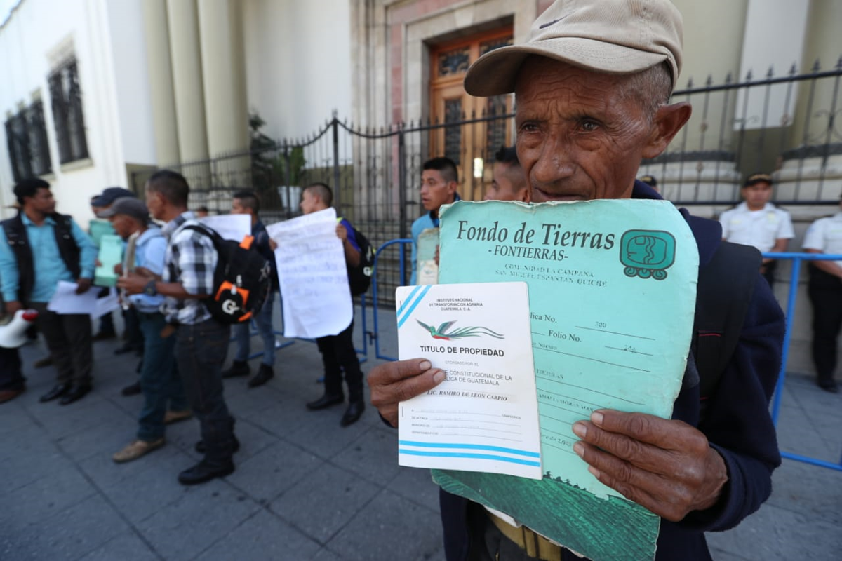 Campesinos muestran títulos de propiedad de los terrenos que, aseguran, les arrebataron para la construcción de la represa de Chixoy. (Foto Prensa Libre: Esbin García)