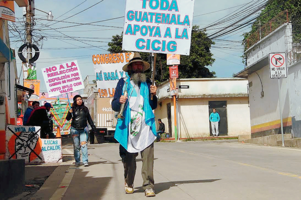 El caminante Oswaldo Ochoa a su paso por Tecpán Guatemala, Chimaltenango, es apoyado por otras personas. (Foto Prensa Libre: José Rosales)