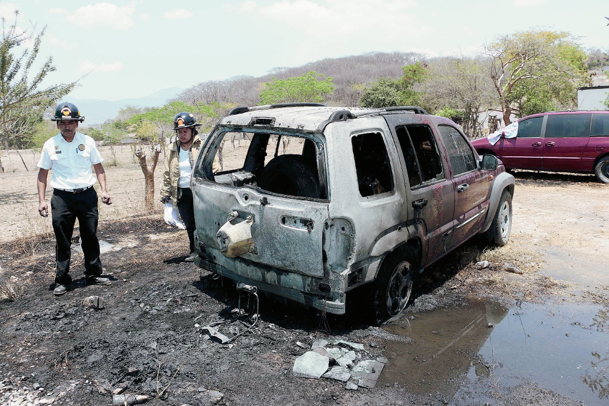 Bomberos observan el vehículo quemado en Salamá, Baja Verapaz. (Foto Prensa Libre: Carlos Grave)