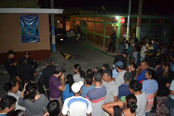 Curiosos observan el cadáver de César Augusto Realmundo López, quien murió baleado, en Sanarate. (Foto Prensa Libre: Hugo Oliva)
