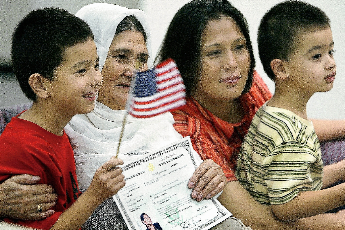 Jowhar Karim —segunda-izq—, originaria de Afganistán, posa para una foto de familia y su nuevo certificado de ciudadanía DE EE.UU. (Foto PrensaLibre:AFP).