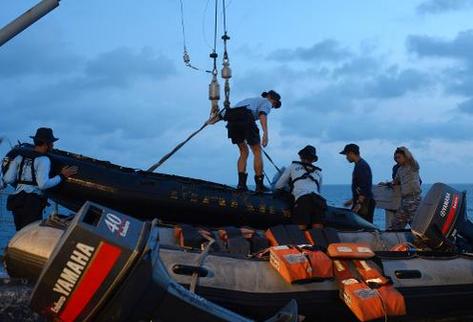 Unos miembros de la Marina indoensia preparan los equipos para introducirlos en el agua. (Foto Prensa Libre: AFP)
