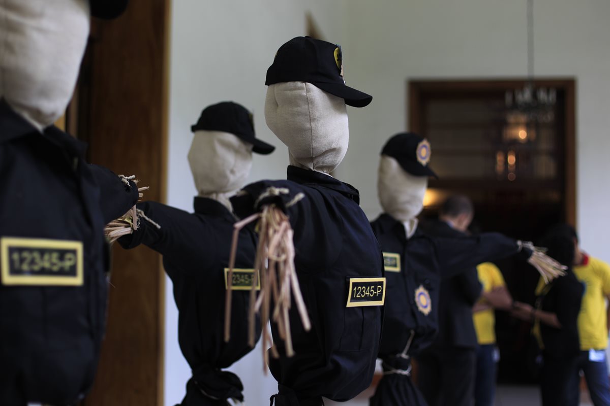 Una marioneta vestida con el uniforme de la Policía identifica un lugar peligroso en la capital. (Foto Prensa Libre: E. Bercian)