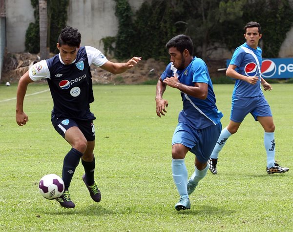 Carlos Salvador Estrada, de la Bicolor, conduce el balón ante el asedio de un defensor de Cremas B (Foto Prensa Libre: Edwin Fajardo)