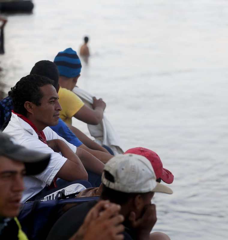 Migrantes hondureños observan desde orilla del río Suchiate a integrantes de Marina mexicana. (Foto Prensa Libre: EFE)