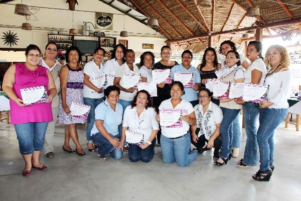 Féminas muestran   el diploma obtenido.