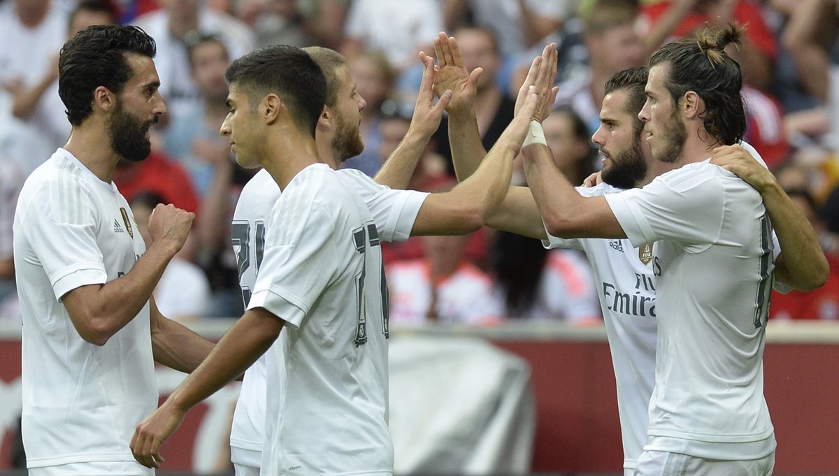 Bale e Isco festejan con sus compañeros luego de la anotación del galés. (Foto Prensa Libre: AFP)