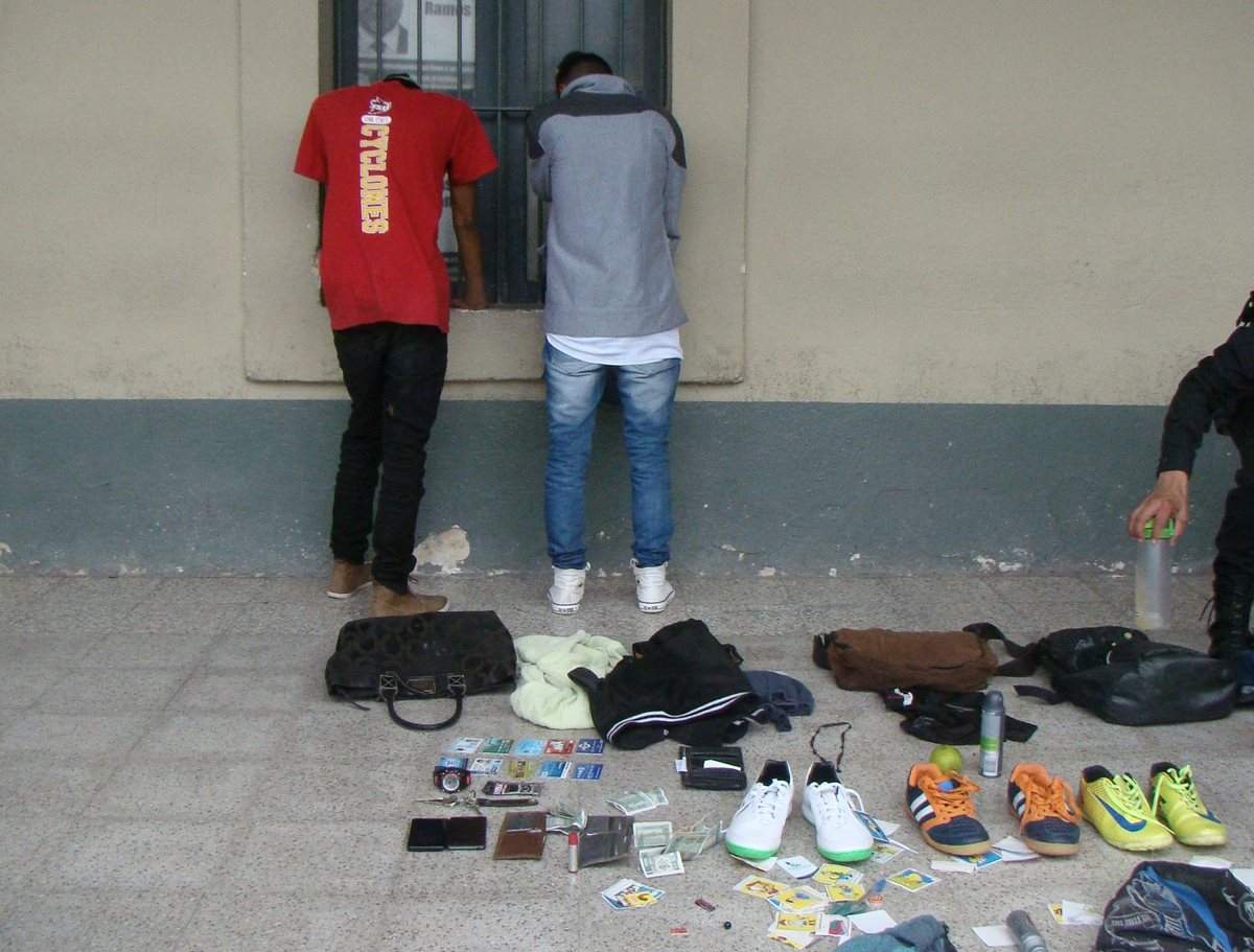 Policía revisa bolsos que habrían sido robados por los dos menores, en la cabecera de Chimaltenango. (Foto Prensa Libre: Víctor Chamalé)