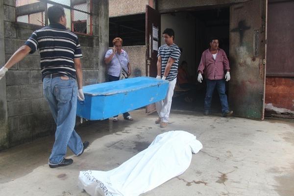 Personal de funeraria traslada a víctimas de ataque en Lívingston, Izabal. (Foto Prensa Libre: Edwin Perdomo)