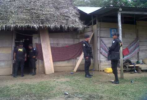 Agentes de la Policía Nacional Civil se hallan en la aldea La Isla, San Luis, Petén, donde un grupo de hombres armados masacró esta mañana a siete integrantes de una familia, y a un trabajador de esta. (Foto Prensa Libre: Rigoberto Escobar)
