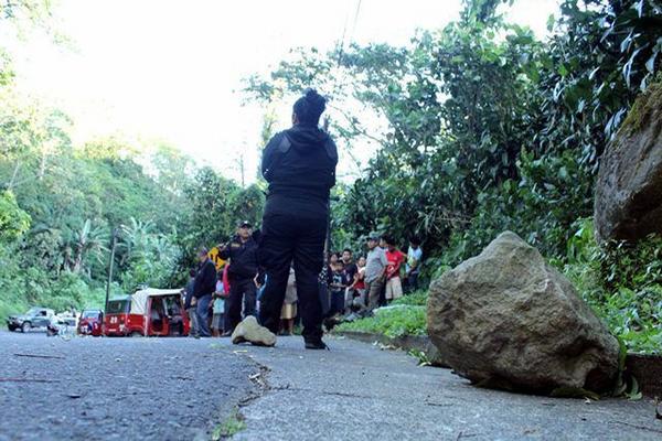 Curiosos permanecen en el lugar donde fue encontrado el cadáver de un hombre, en San Felipe, Retalhuleu. (Foto Prensa Libre: Rolando Miranda) <br _mce_bogus="1"/>