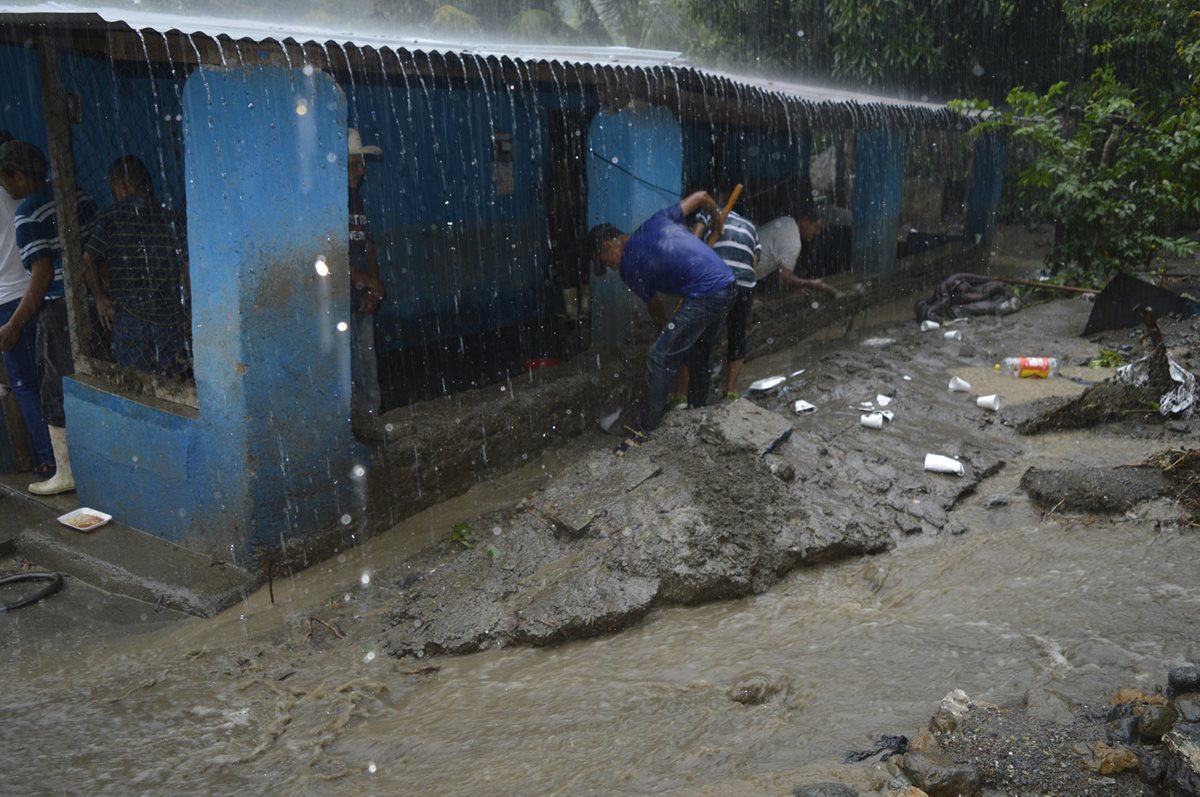 Pobladores tratan de proteger sus viviendas de las inundaciones. (Foto Prensa Libre: Mario Morales).