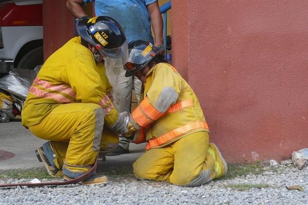 Dos socorristas participan en el simulacro de incendio realizado en Puerto Barrios. (Foto Prensa Libre: Edwin Perdomo) <br _mce_bogus="1"/>
