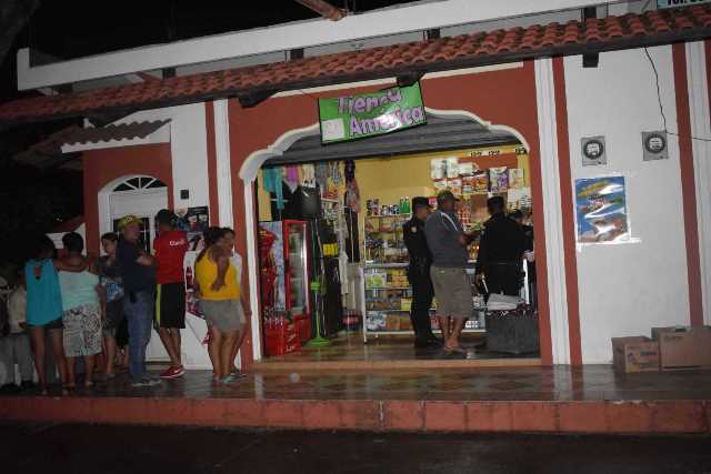 Agentes de la PNC resguardan escena en el interior de la tienda en que fue ultimada la expolicía. (Foto Prensa Libre: Mario Morales)