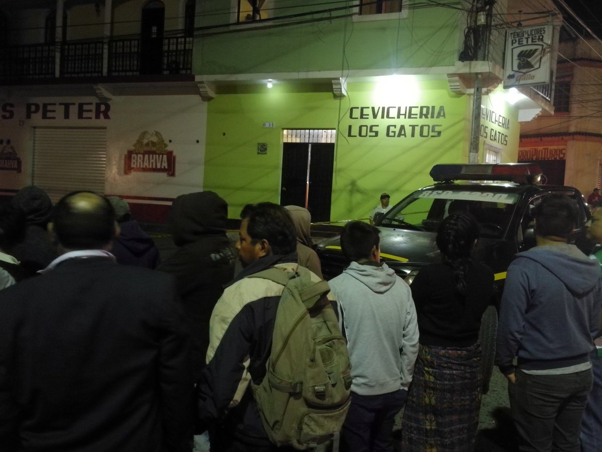 Curiosos observan hacia la cevichería donde esta noche un joven de 20 años perdió la vida a balazos. (Foto Prensa Libre: Fred Rivera)