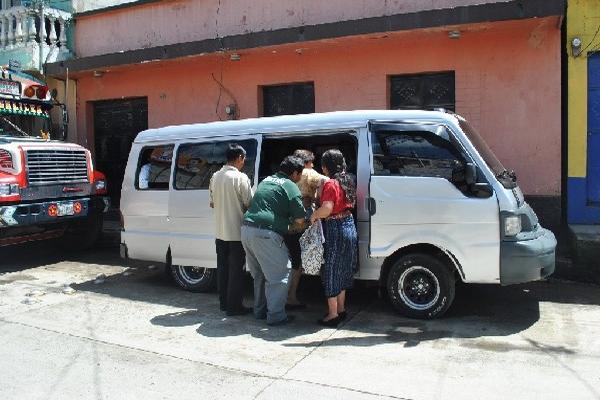 Vecinos  abordan uno de los microbuses que prestan servicio en San Juan Comalapa.
